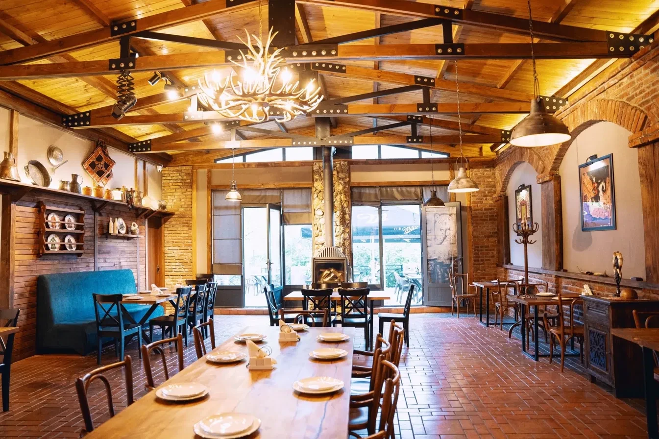 Restaurant interior with antler chandelier and timber beams
