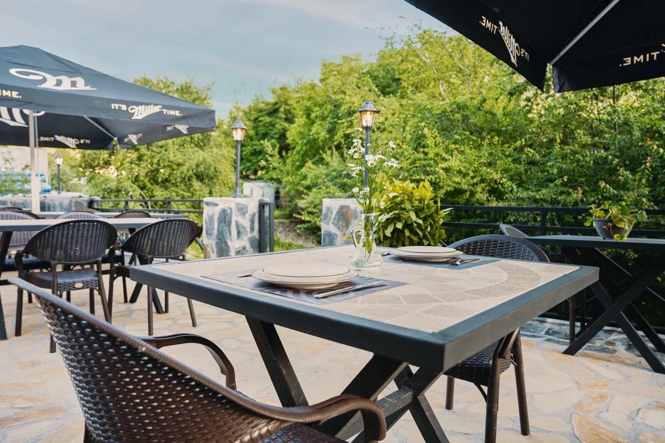 Terrace tables under umbrellas, open to the Svaneti sky